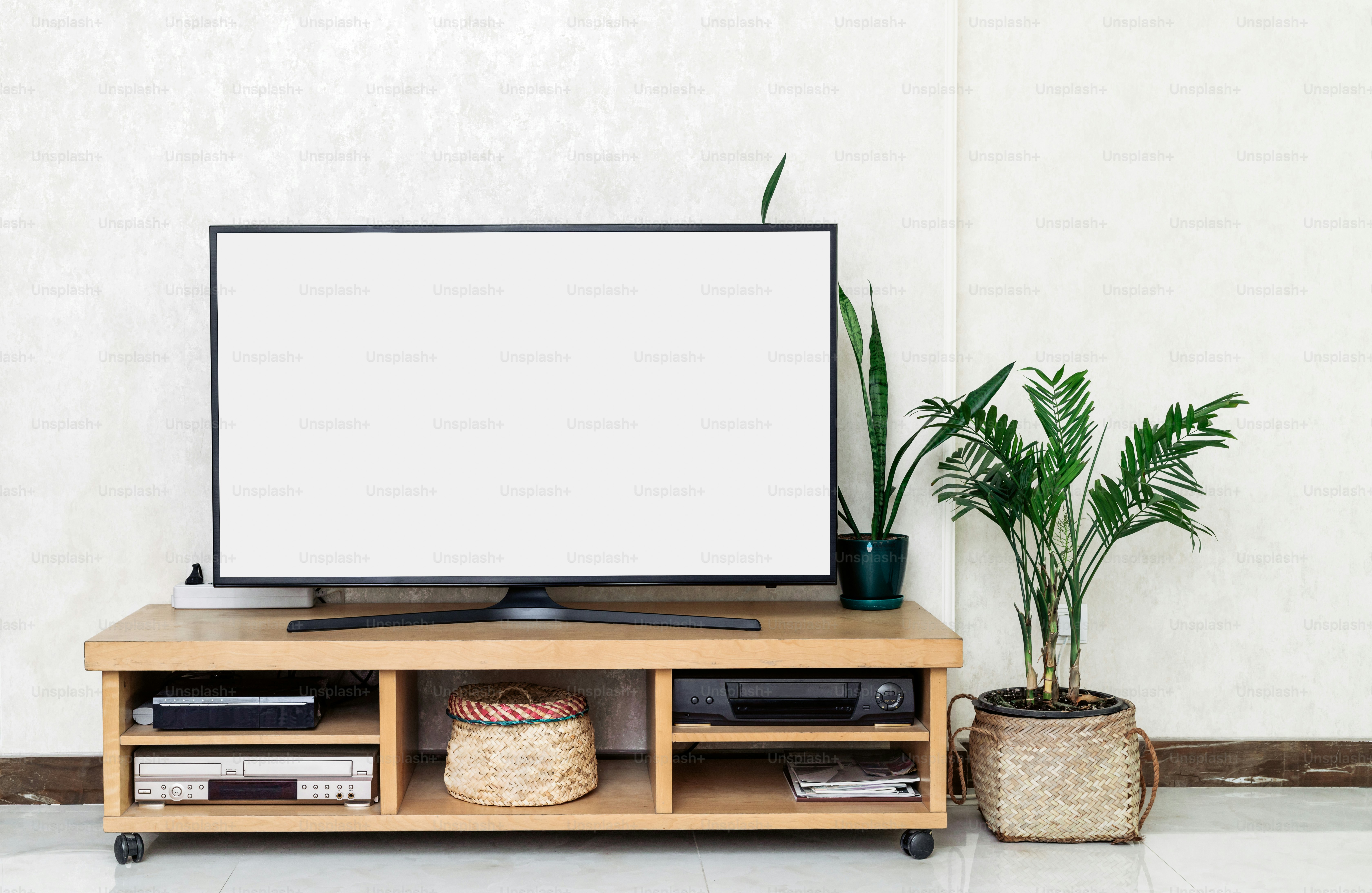 a flat screen tv sitting on top of a wooden stand